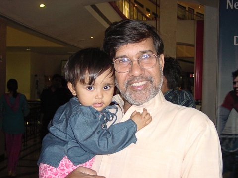 Kailash Satyarthi holding a child.